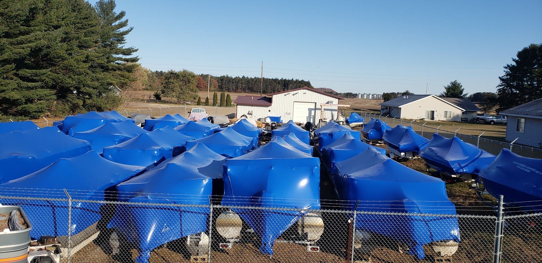 Dozens of boats shrink wrapped for winter storage at Anchor Marine in Menomonie Wisconsin serving boat owners from Eau Claire and the Chippewa Valley