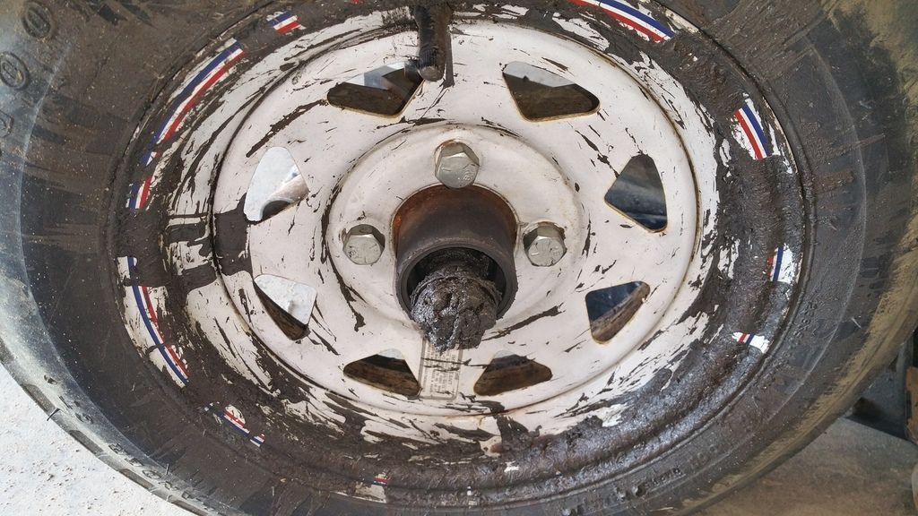 Severe boat trailer wheel bearing failure with grease and metal debris from overheated hub requiring repair at Anchor Marine in Menomonie Wisconsin