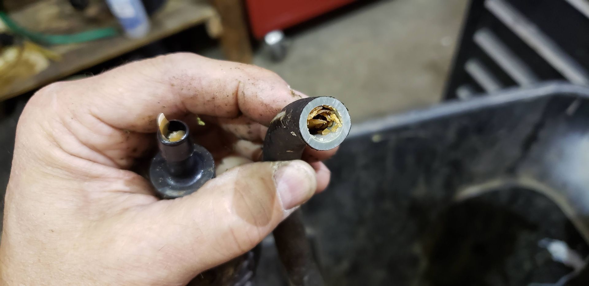 Close-up of a deteriorated inner liner inside a boat fuel hose caused by ethanol fuel exposure during outboard repair at Anchor Marine in Menomonie Wisconsin serving the Eau Claire area