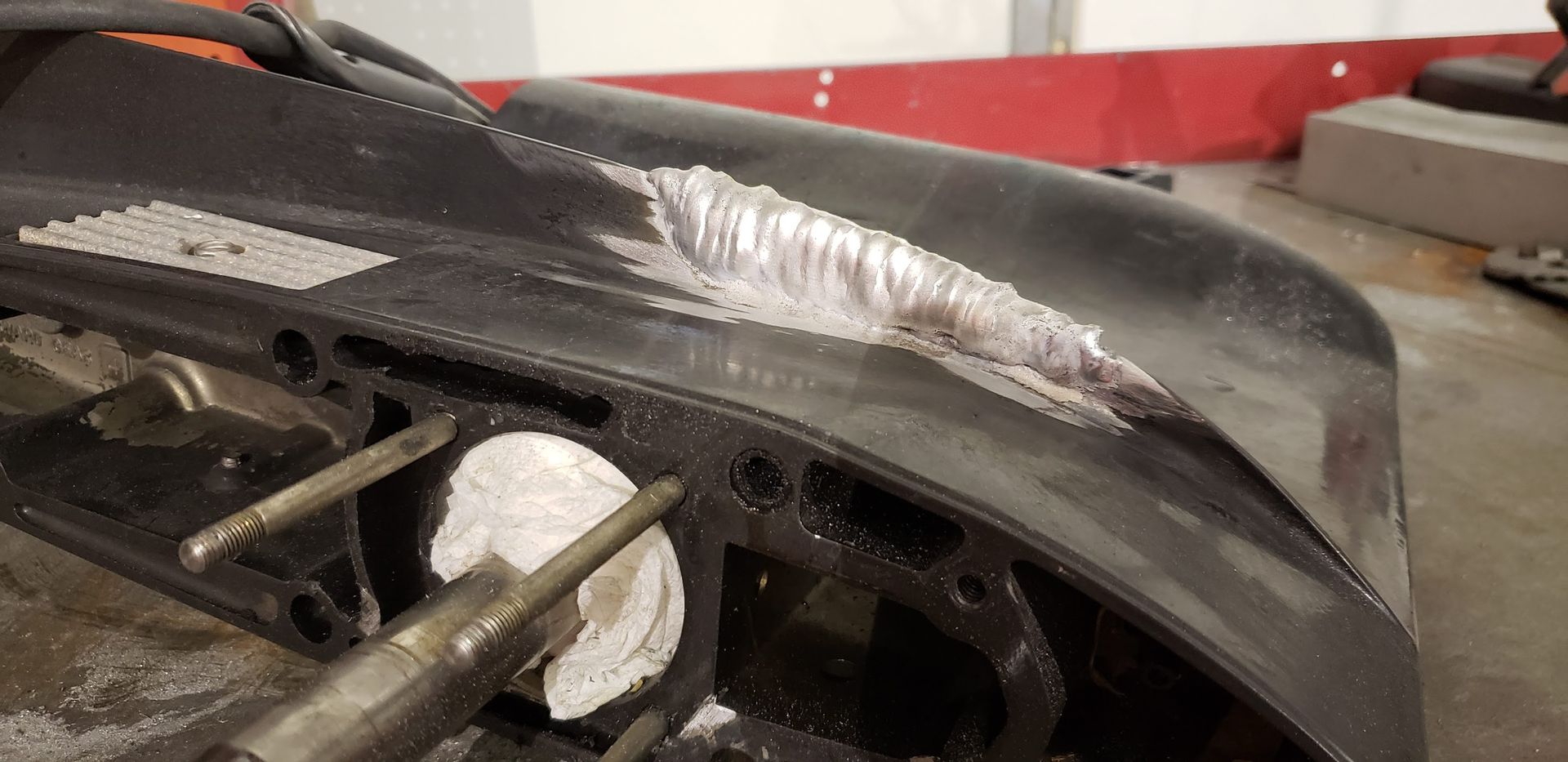 Aluminum welding repair on the anti-ventilation plate of a Force outboard lower unit at Anchor Marine boat repair shop in Menomonie Wisconsin serving the Eau Claire area
