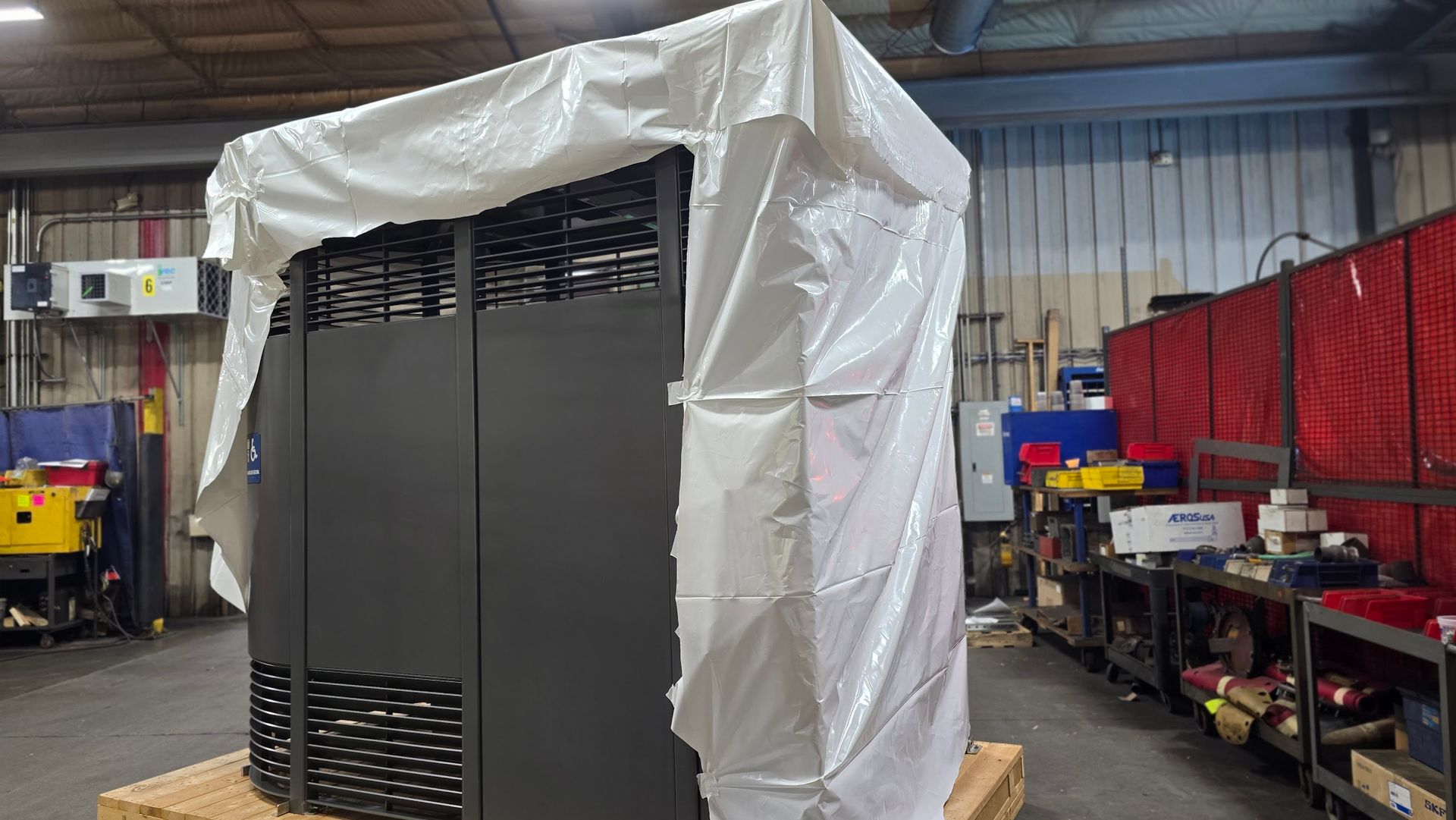 Large industrial equipment shrink wrapped for freight shipping protection at Anchor Marine in Menomonie Wisconsin