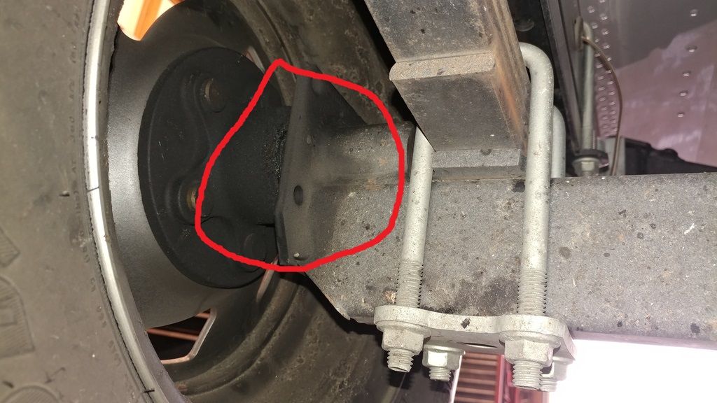 Leaking boat trailer bearing seal showing grease loss at hub on leaf spring axle repaired at Anchor Marine in Menomonie Wisconsin