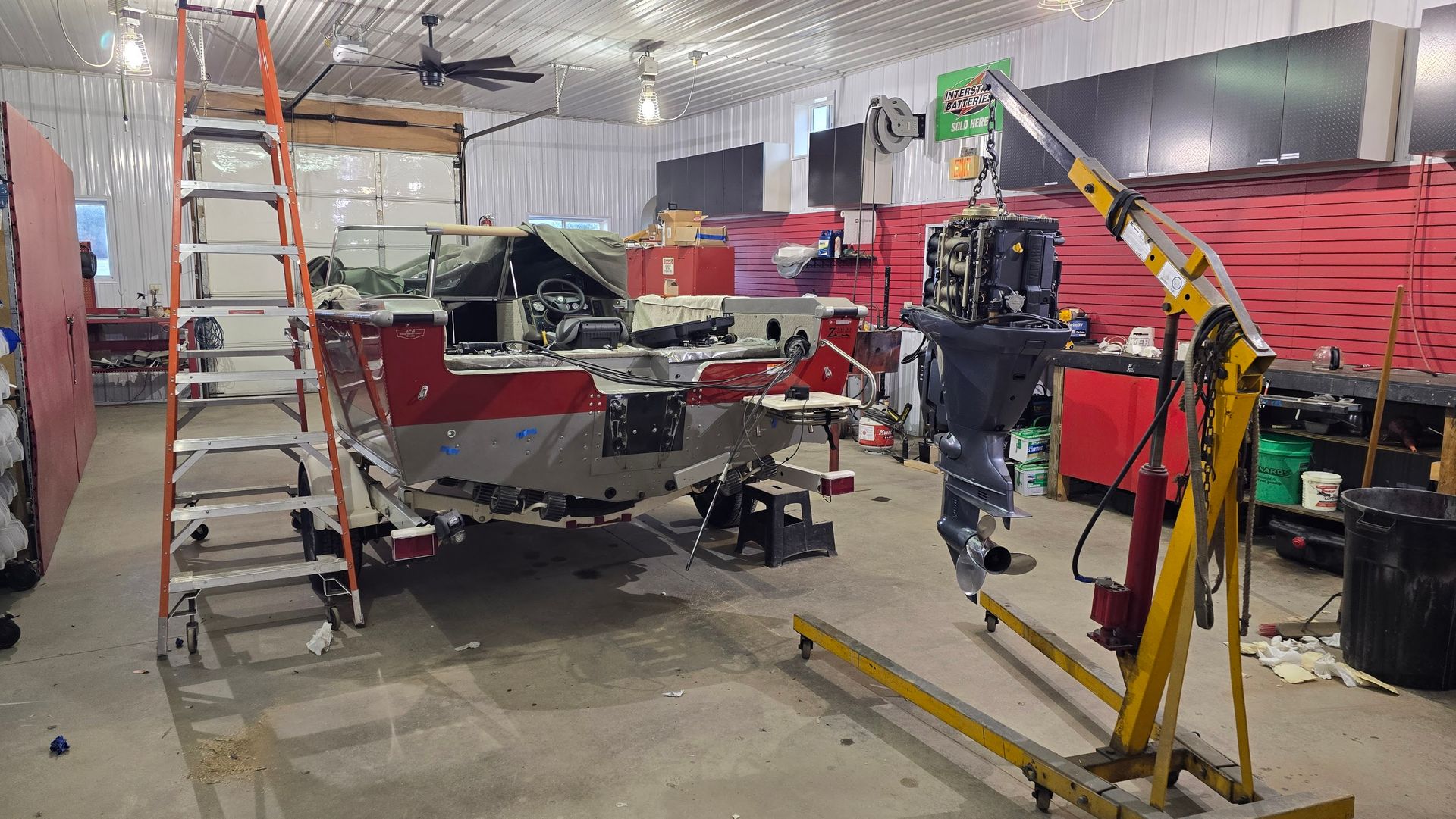 Lund aluminum fishing boat with Yamaha outboard removed at the start of transom repair inside Anchor Marine in Menomonie Wisconsin serving the Eau Claire and Chippewa Valley area