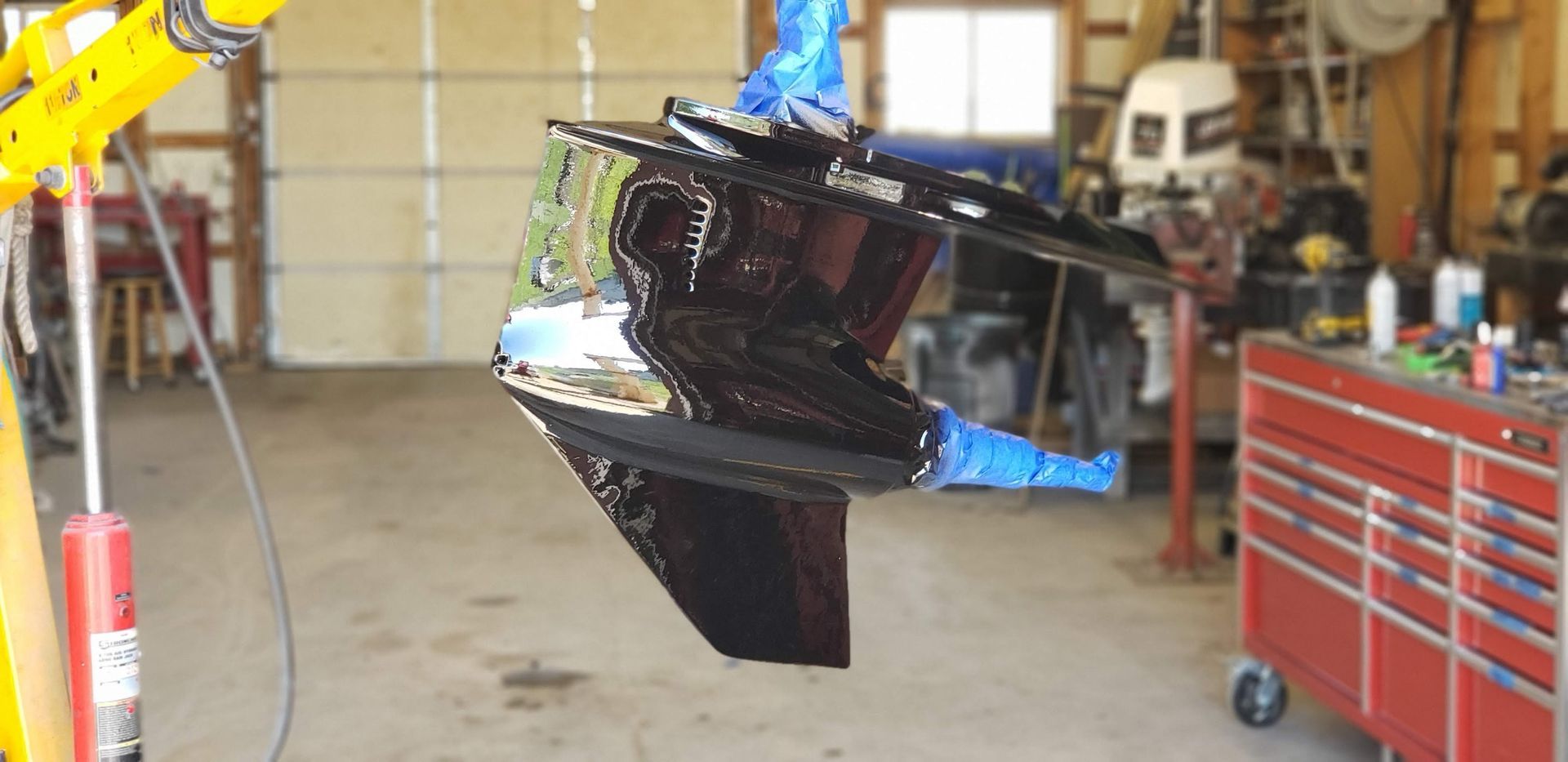 MerCruiser Bravo Three sterndrive lower unit after skeg repair, aluminum welding, and refinishing, freshly painted and ready for reinstallation at Anchor Marine boat repair shop in Menomonie Wisconsin serving the Eau Claire area