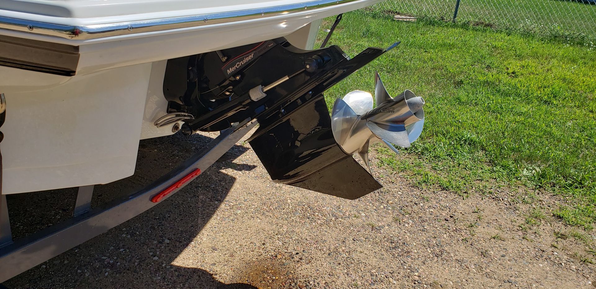 MerCruiser Bravo Three sterndrive after skeg repair and lower unit refinishing with stainless steel dual propellers installed on the boat at Anchor Marine boat repair shop in Menomonie Wisconsin serving the Eau Claire area