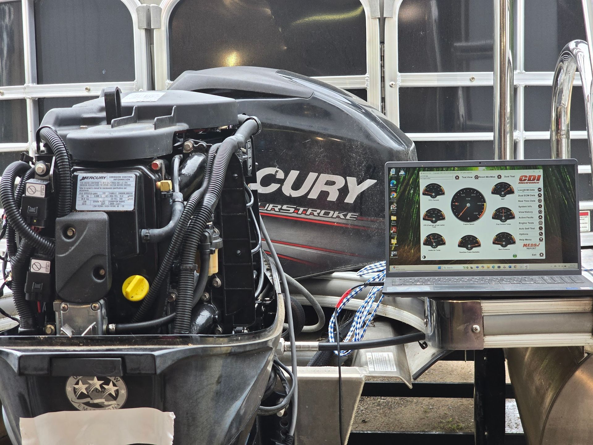 Laptop connected to a Mercury FourStroke outboard engine displaying diagnostic data during troubleshooting at Anchor Marine in Menomonie Wisconsin serving the Eau Claire boating area