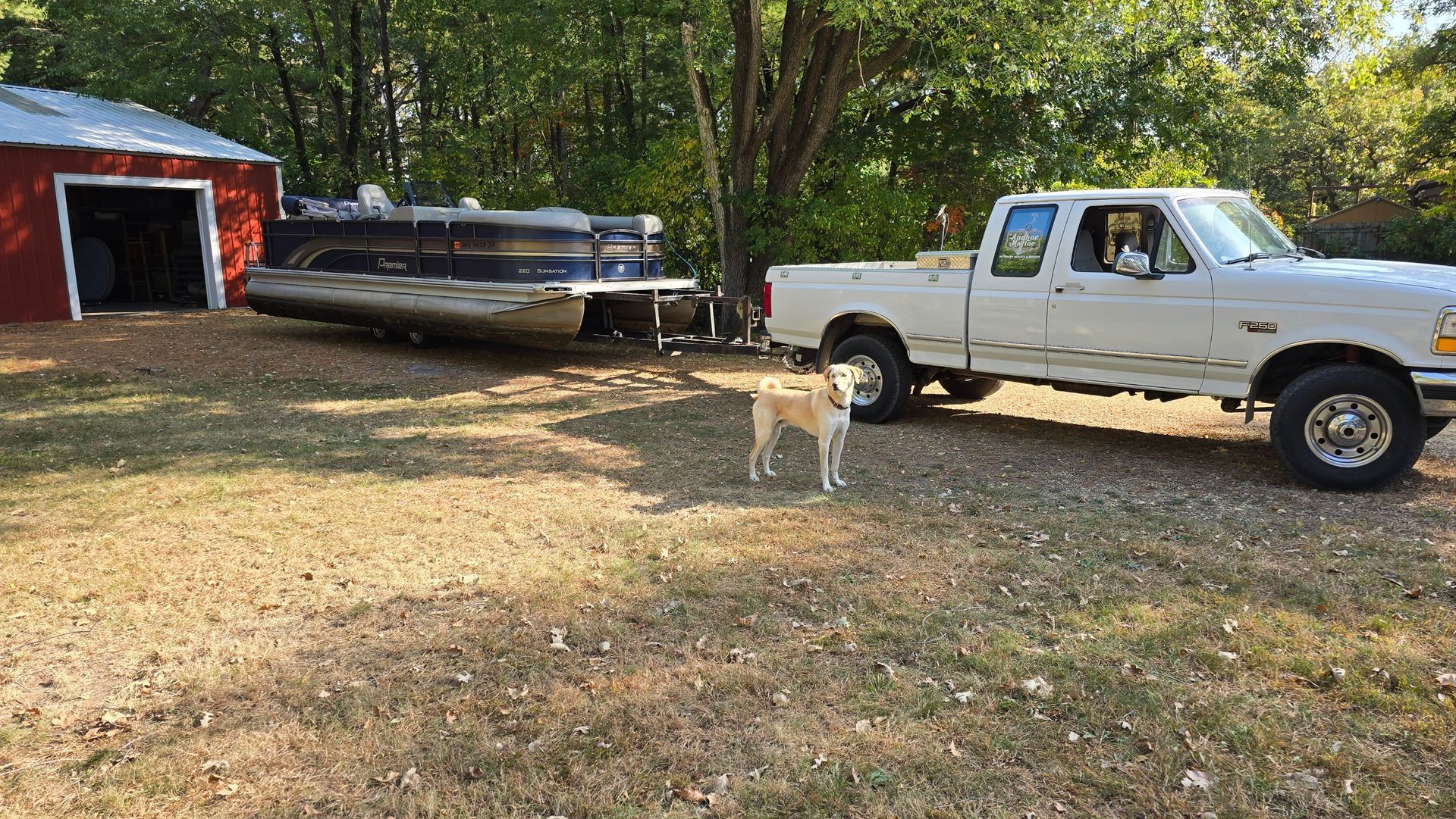 pontoon boat delivery to customer property near Lake Menomin and Eau Claire Wisconsin showing insured transport and placement at residential location