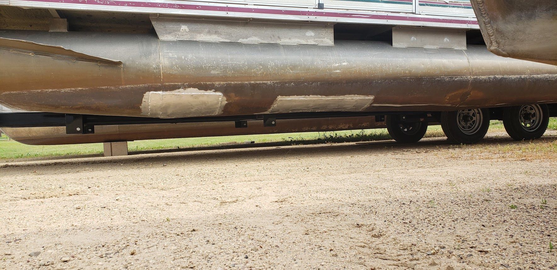 Damaged pontoon log repaired with welded aluminum patches in Menomonie WI near Lake Tainter and Eau Claire by Anchor Marine