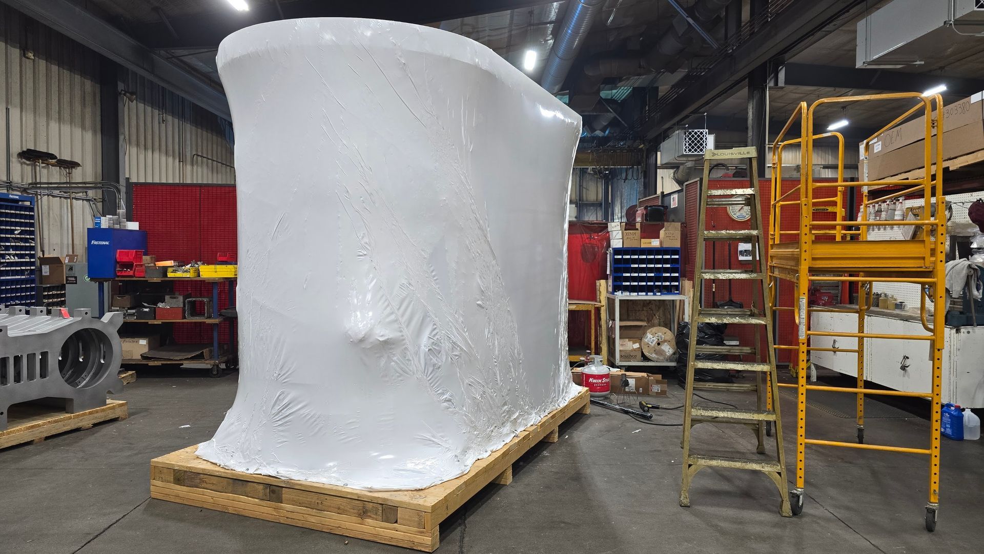 Portland Loo public restroom structure fully shrink wrapped for freight shipping protection at Anchor Marine in Menomonie Wisconsin