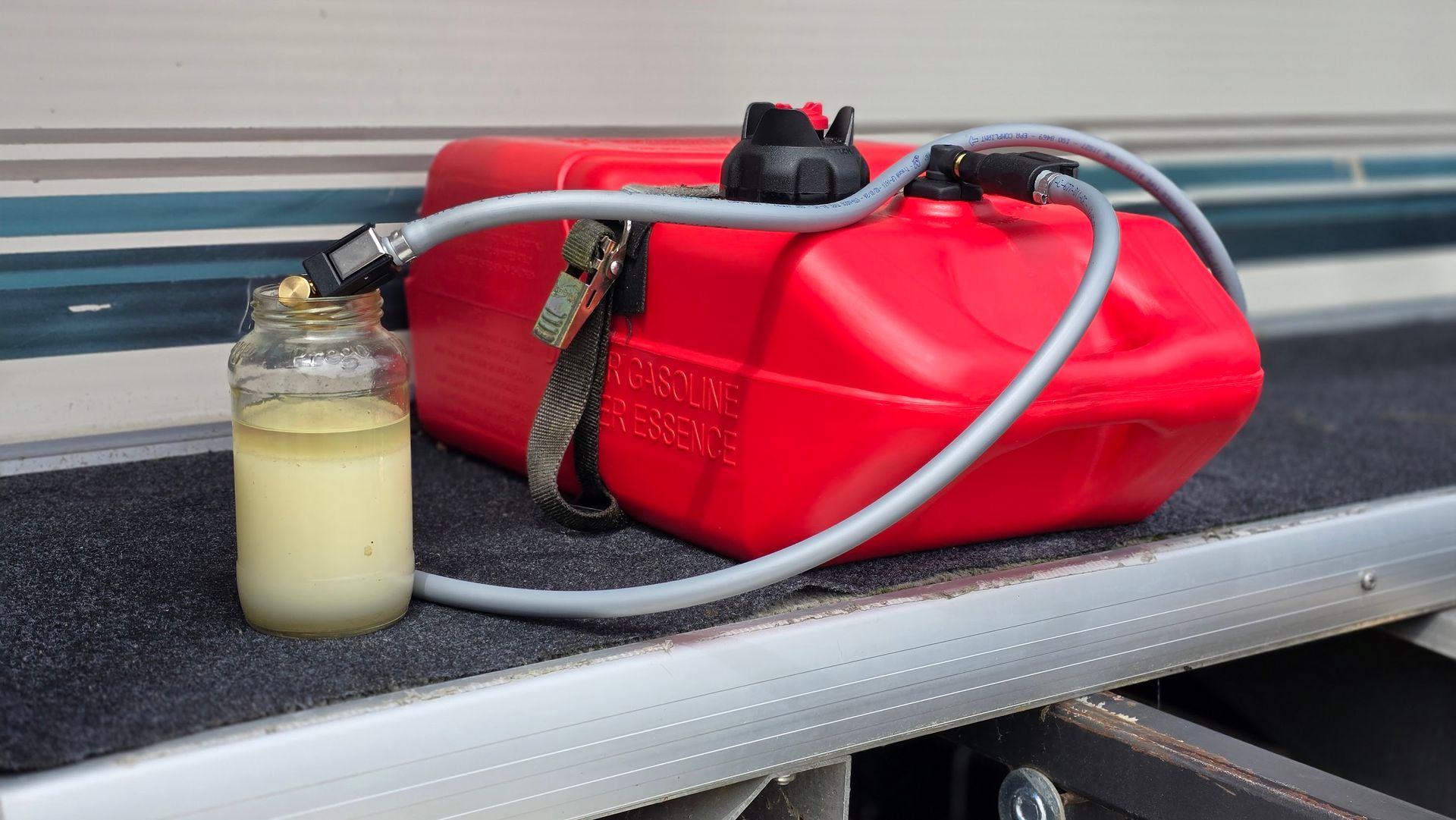 Water-contaminated gasoline separated in a fuel sample jar during boat fuel system diagnosis at Anchor Marine in Menomonie Wisconsin serving Eau Claire area boat owners