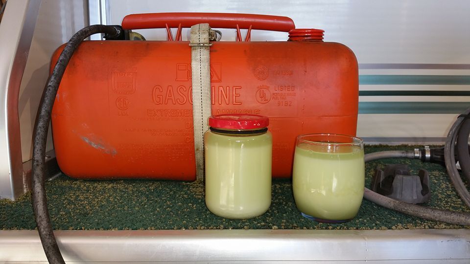 Water-contaminated gasoline drained from a boat fuel tank during an outboard engine diagnostic inspection at Anchor Marine in Menomonie Wisconsin serving the Eau Claire area