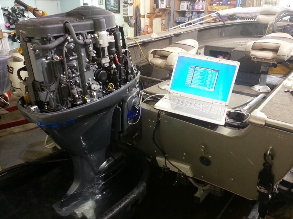 Laptop connected to a Yamaha outboard engine for computer diagnostics and troubleshooting at Anchor Marine in Menomonie Wisconsin serving the Eau Claire boating area