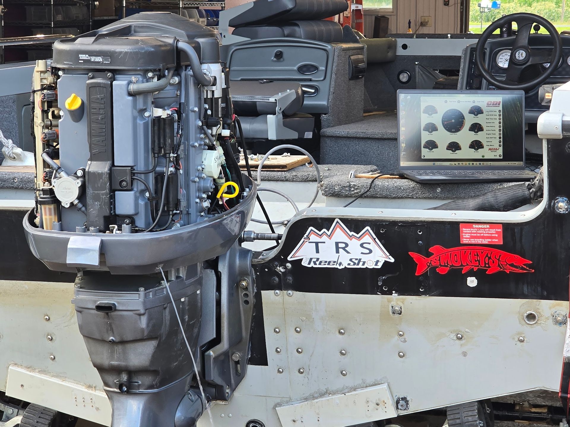 Yamaha outboard engine connected to diagnostic software for computer testing and troubleshooting at Anchor Marine boat repair shop in Menomonie Wisconsin serving the Eau Claire area