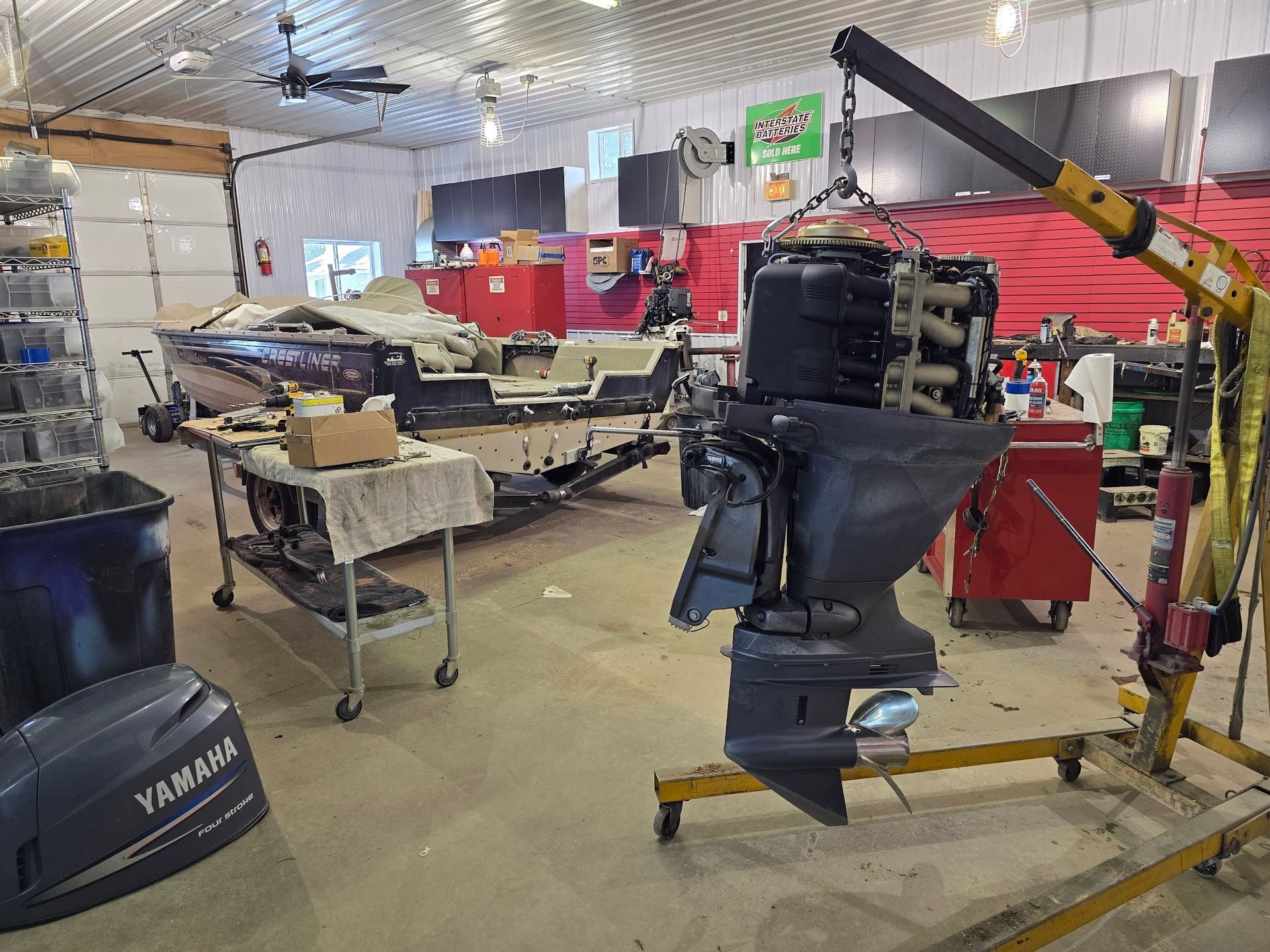 Yamaha outboard motor being serviced inside the Anchor Marine repair shop in Menomonie Wisconsin serving boat owners from Eau Claire and the Chippewa Valley