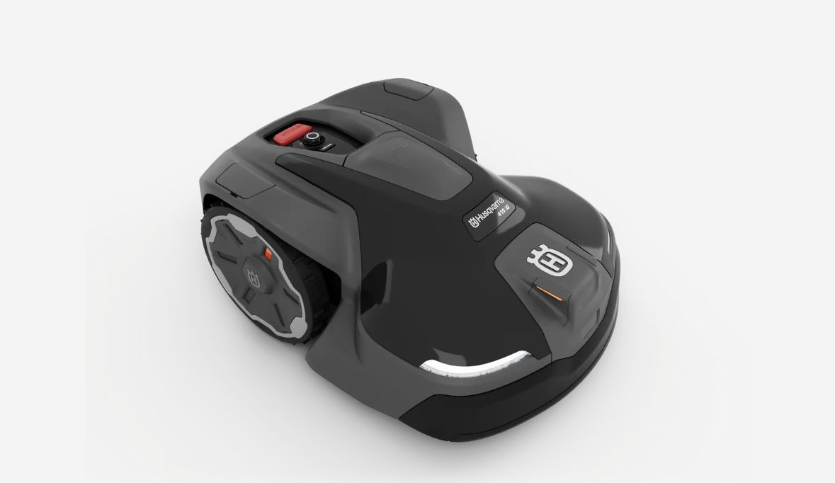 Black and gray Husqvarna Automower robotic lawnmower on white background.