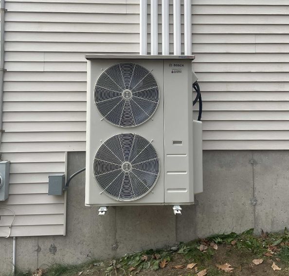 a large air conditioner is mounted on the side of a house