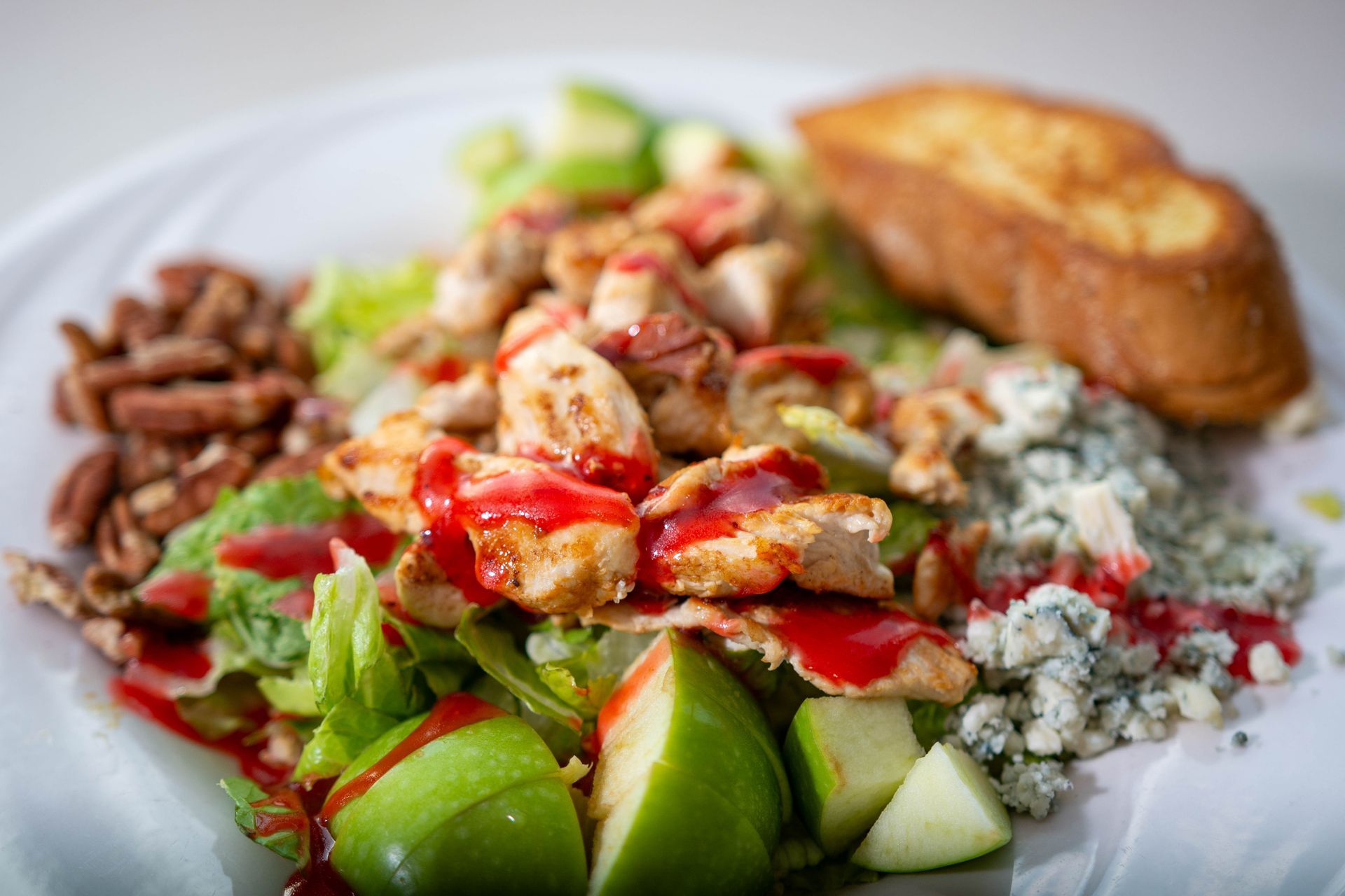 Salad plate with tomatoes, cucumbers, blue cheese, beans, and toasted bread