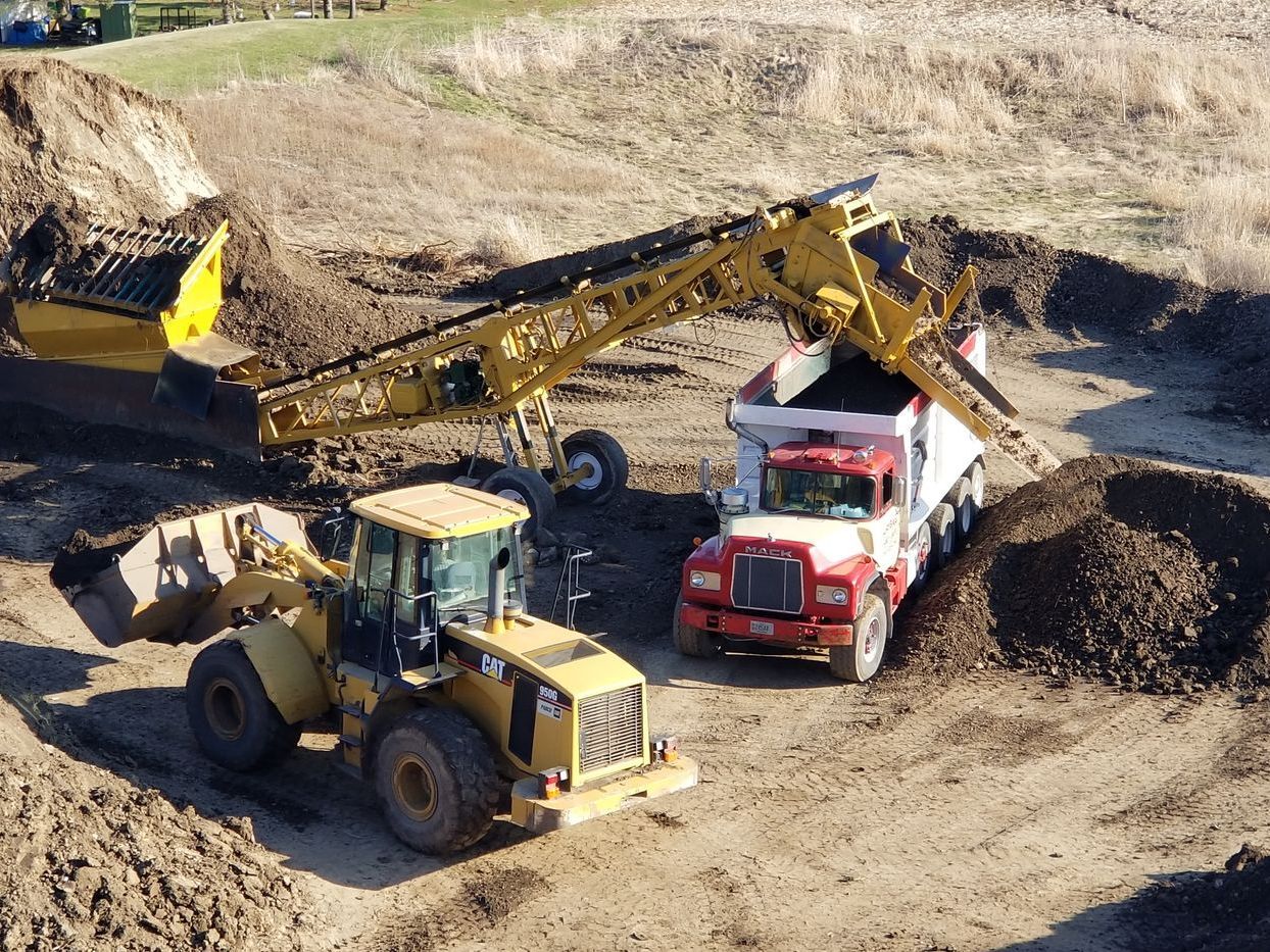 Putting top soil on to truck