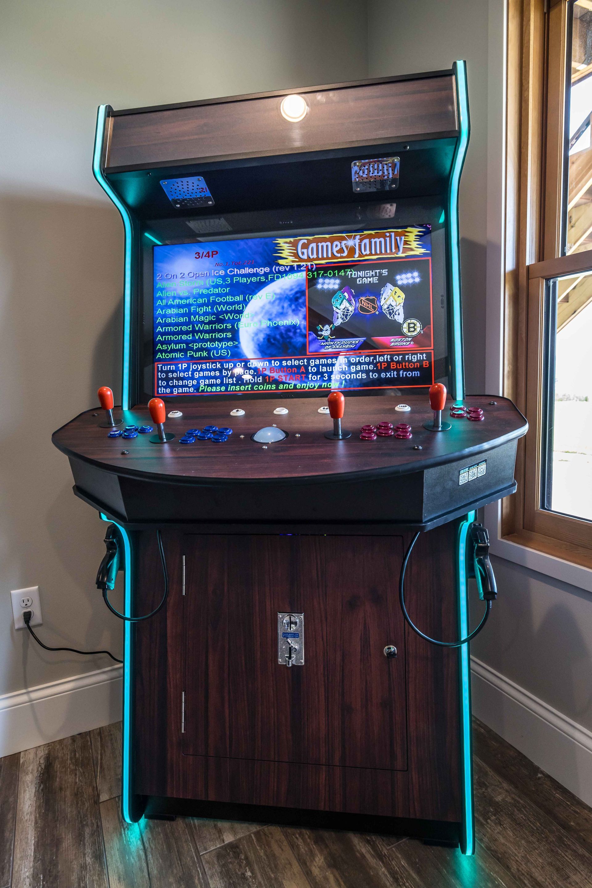 Arcade cabinet with a lit blue trim, displaying a game screen and controls.