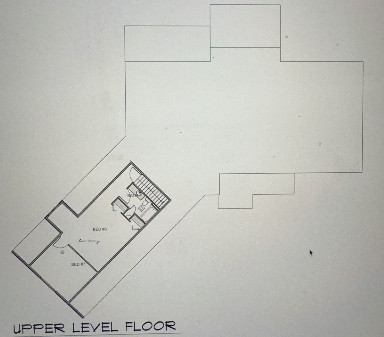 Upper-level floor plan with an irregular shape and rooms labeled 