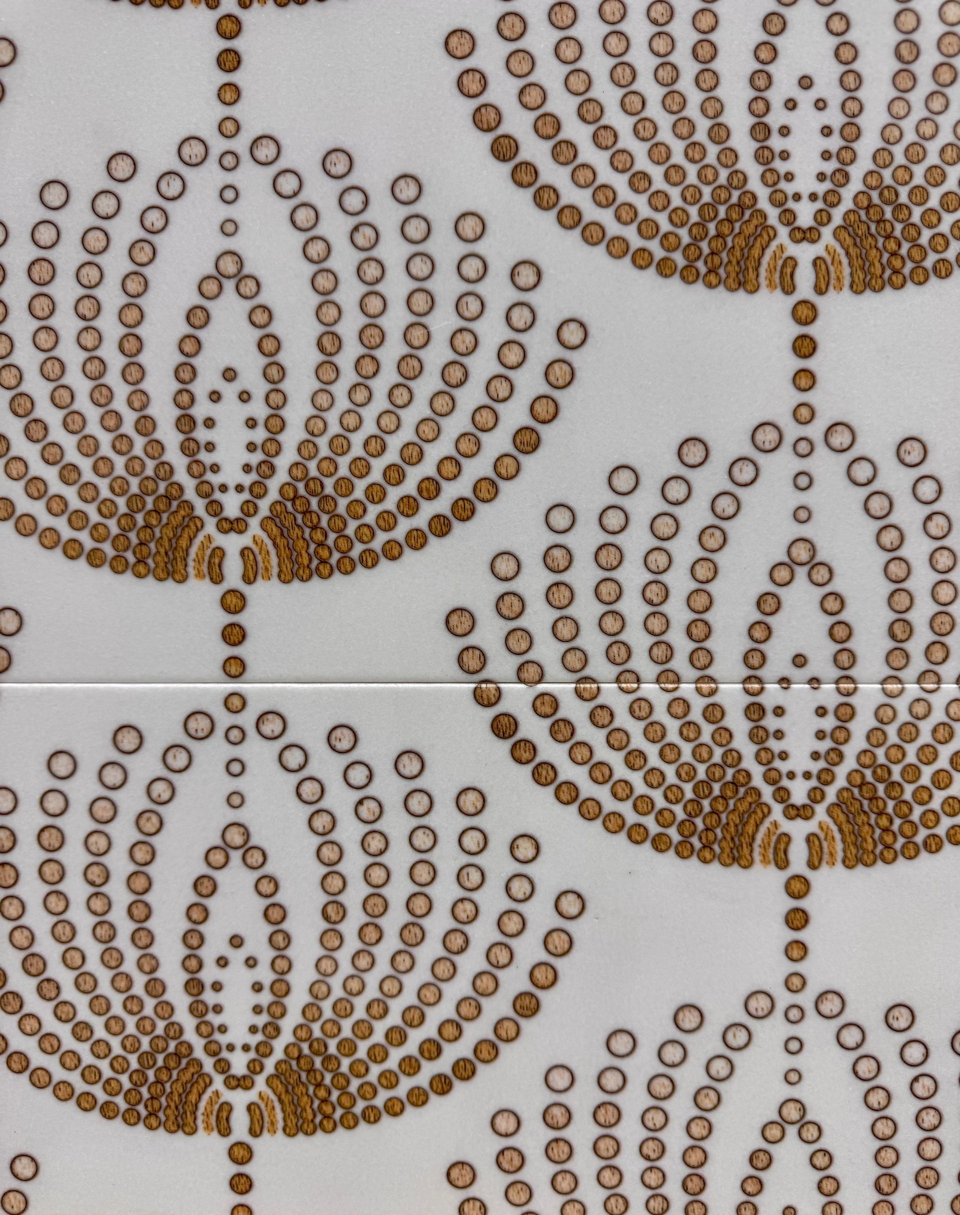 Two brown beaded floral ornaments on a light background, arranged in a tiled pattern