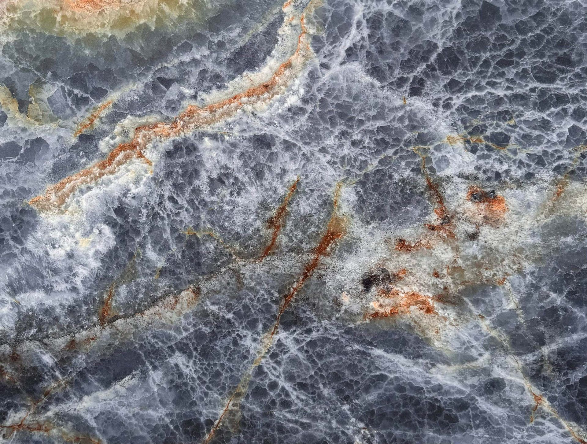 Gray marble-like stone with white veining and rust-colored streaks
