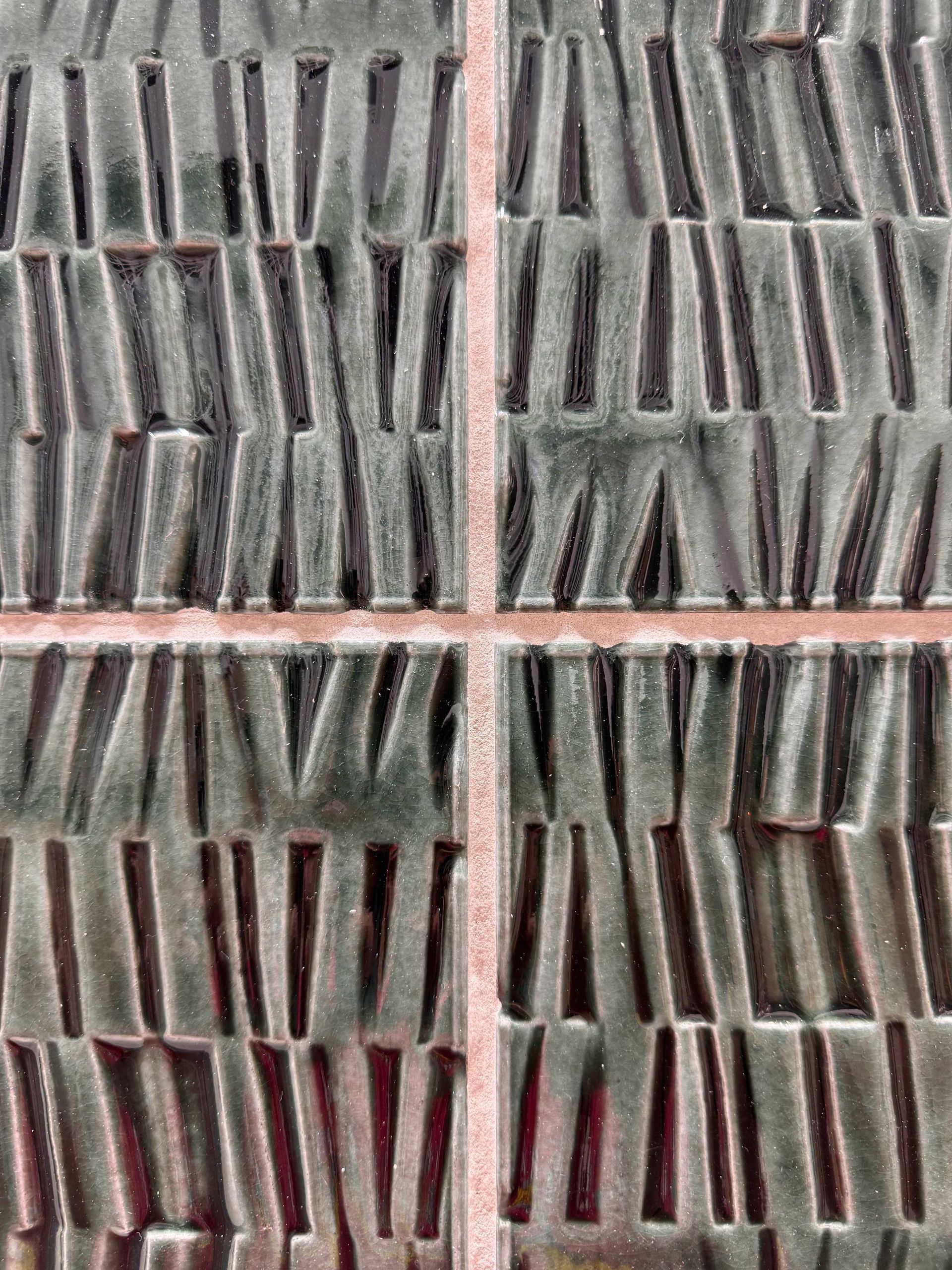 Close-up of gray and pink fabric with repeating vertical pleated texture