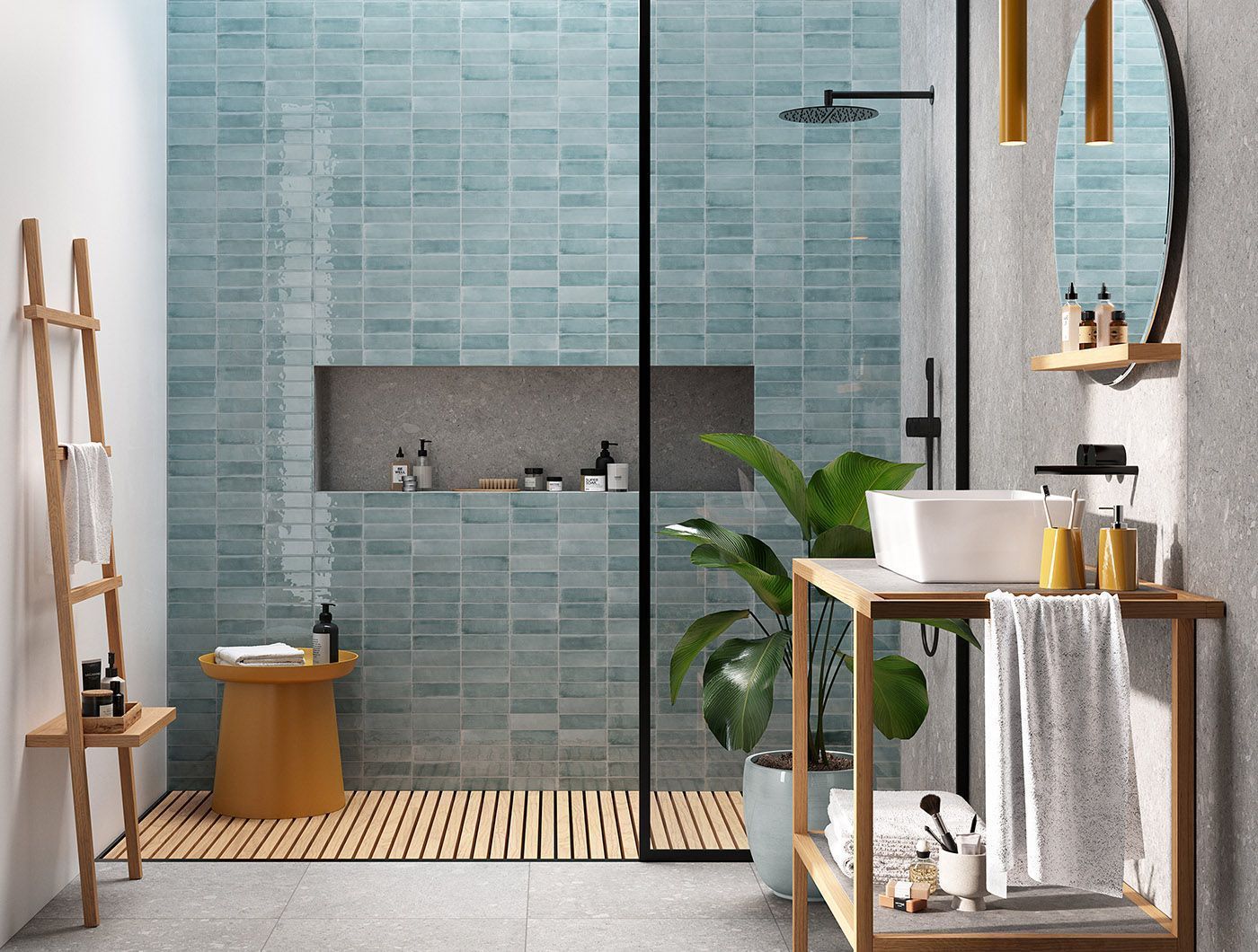 Modern bathroom with blue tile shower, glass enclosure, wooden accents, and potted plant.
