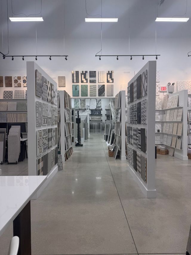 A bright art supply store aisle with shelves of prints and notebooks under overhead lights.
