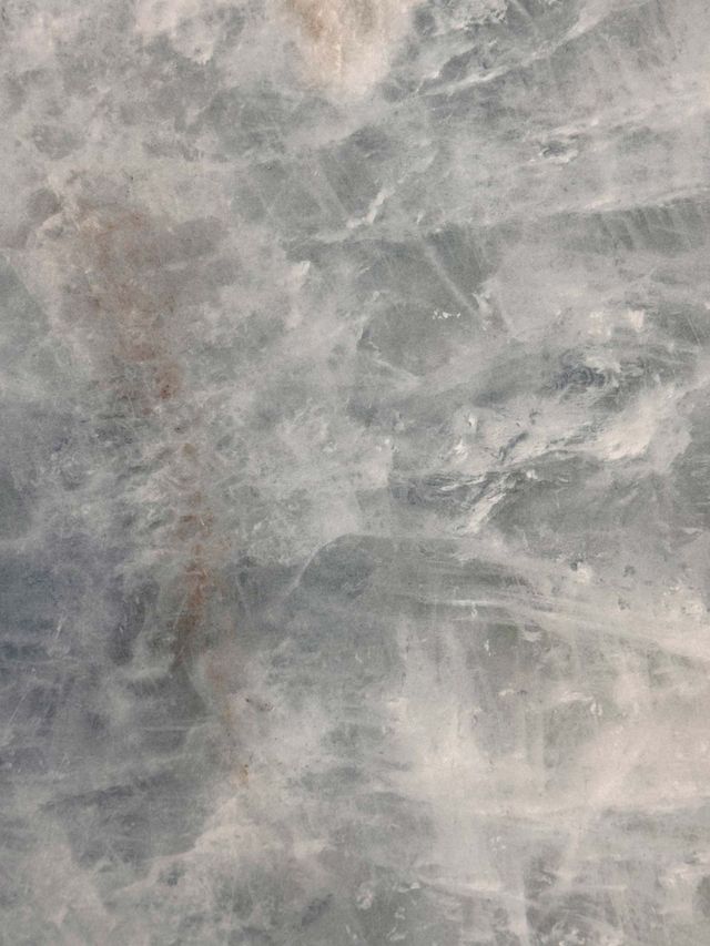 Gray and white marbled stone surface with cloudy veining and texture