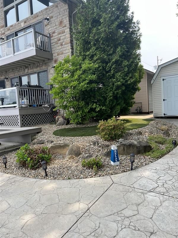 There is a shed in the backyard of a house.