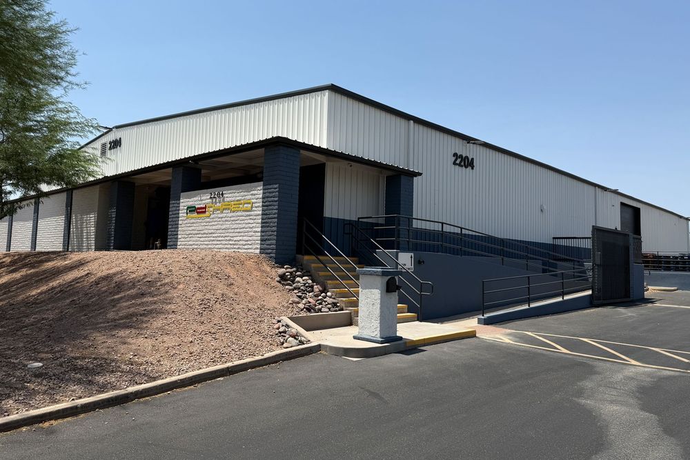 Warehouse building with a ramp and steps. Exterior view, blue and white color scheme.