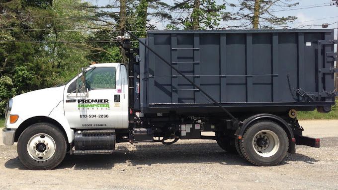 A dump truck is parked on the side of the road.
