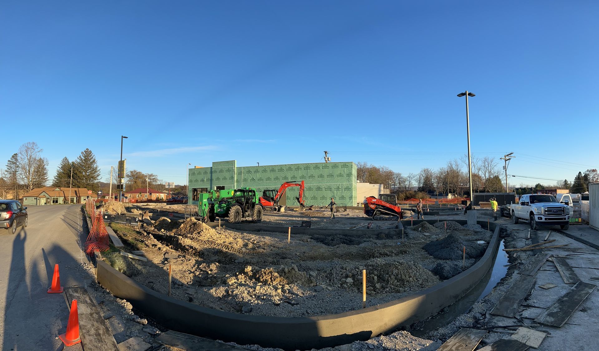 A construction site with a lot of trucks and tractors.
