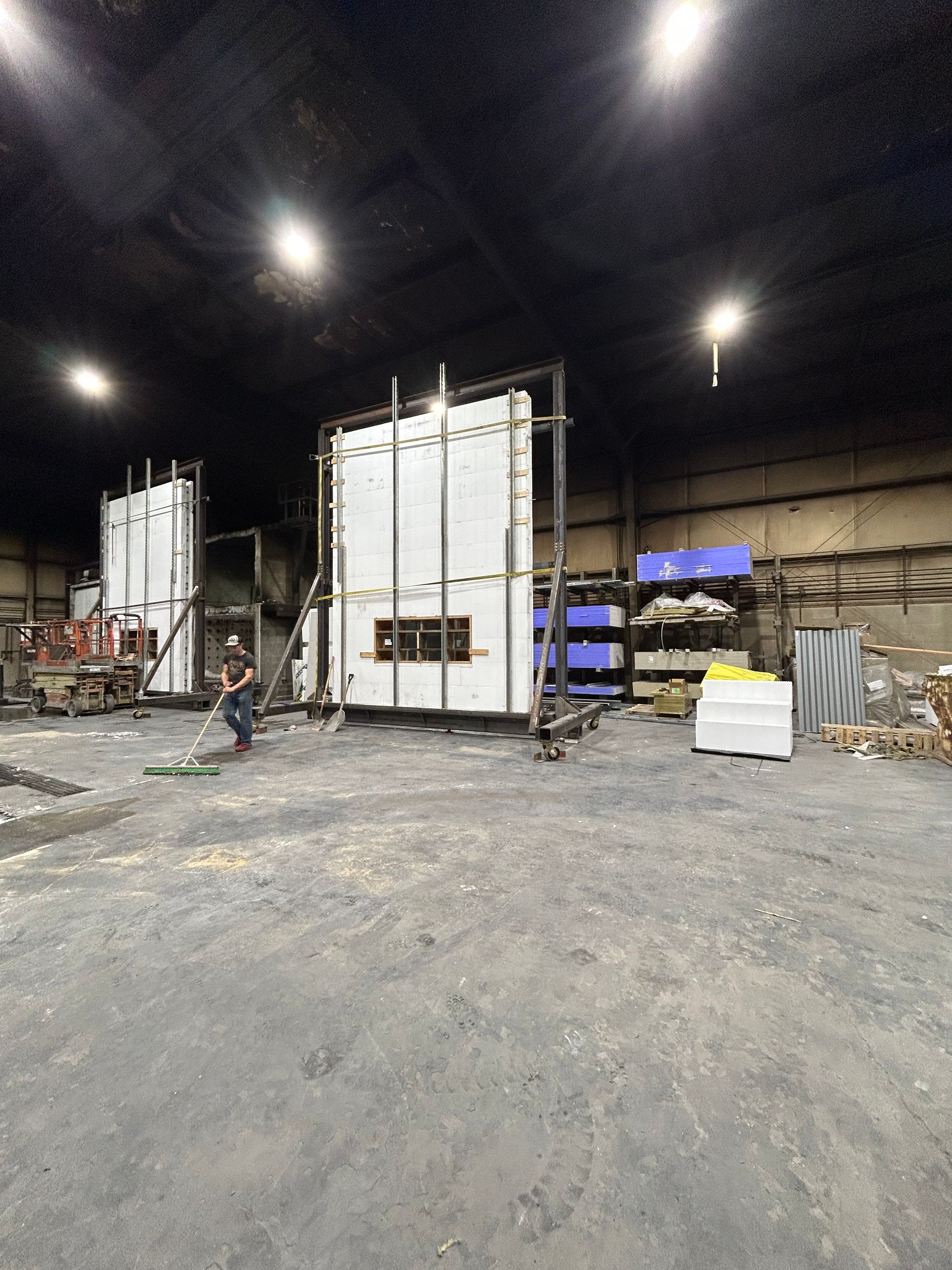 A large warehouse with a lot of boxes on the floor