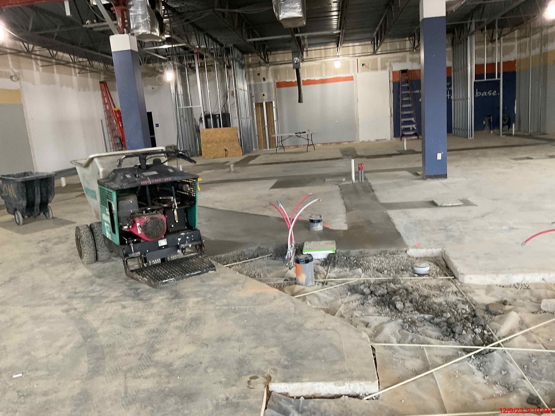 A machine is sitting in the middle of an empty room.