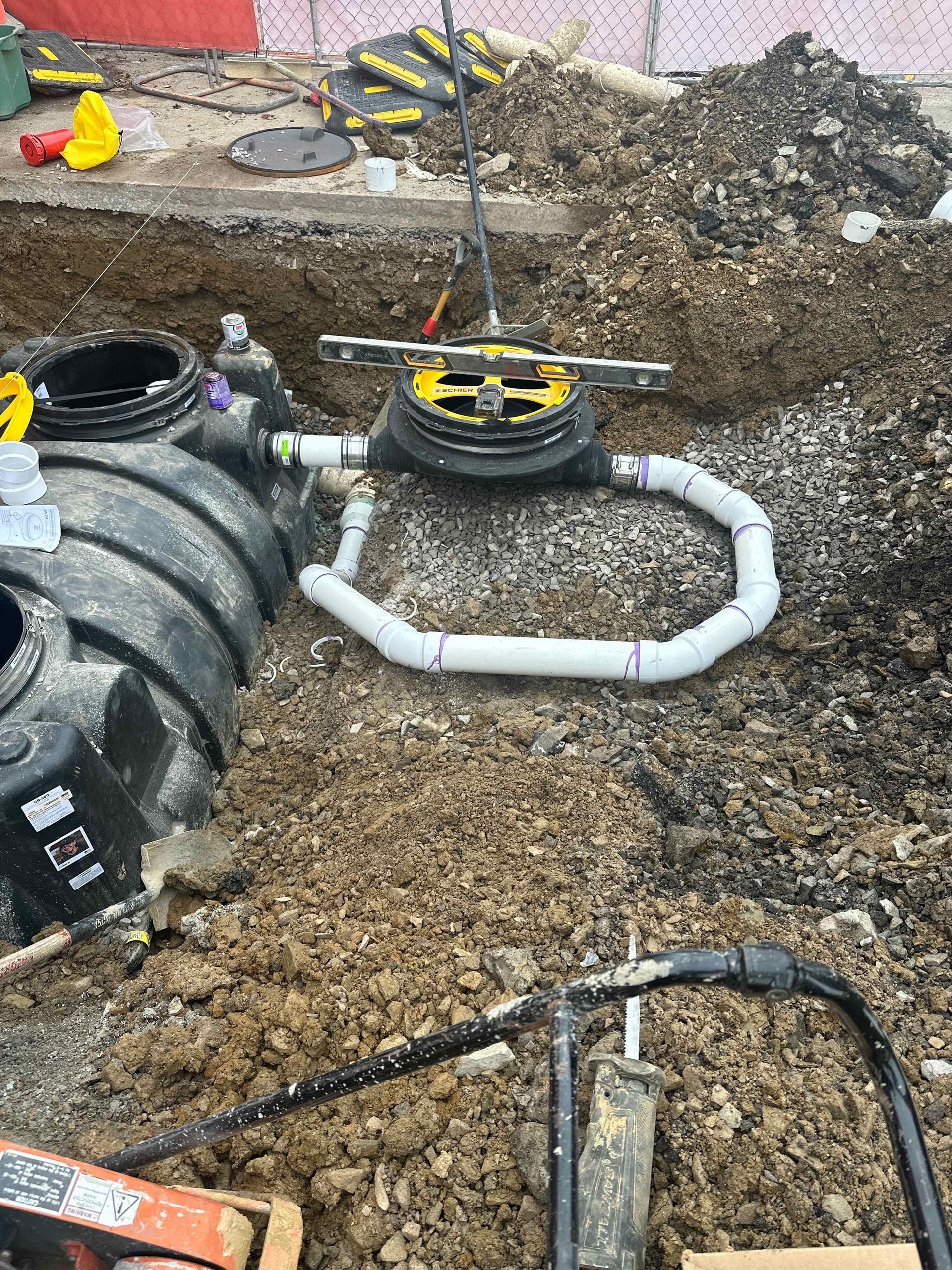A septic tank is being installed in the dirt.