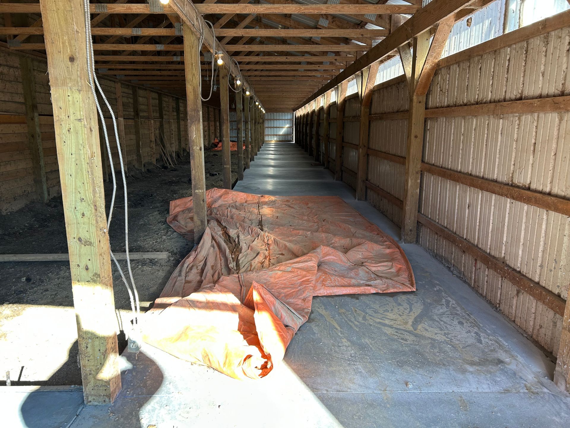 A long hallway in a building with a tarp on the floor.