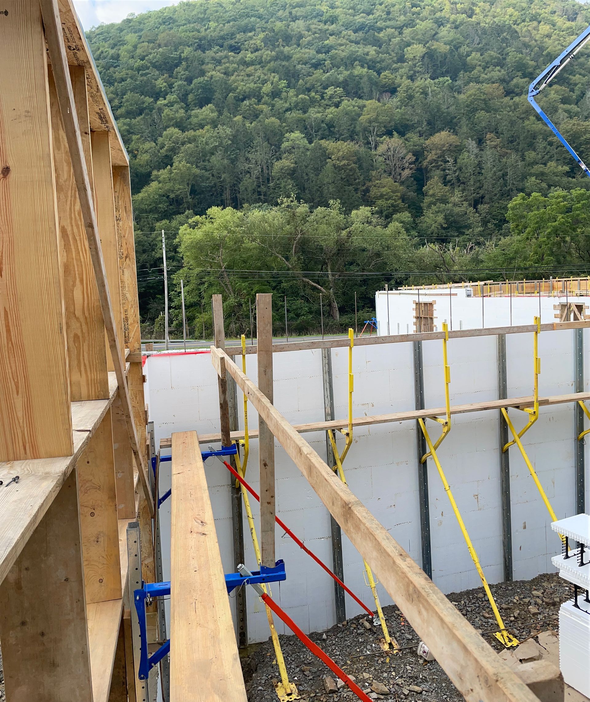 A construction site with a concrete pump in the background.