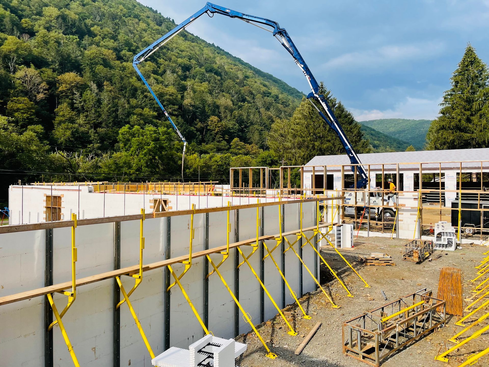 A large building is being built with a concrete pump.