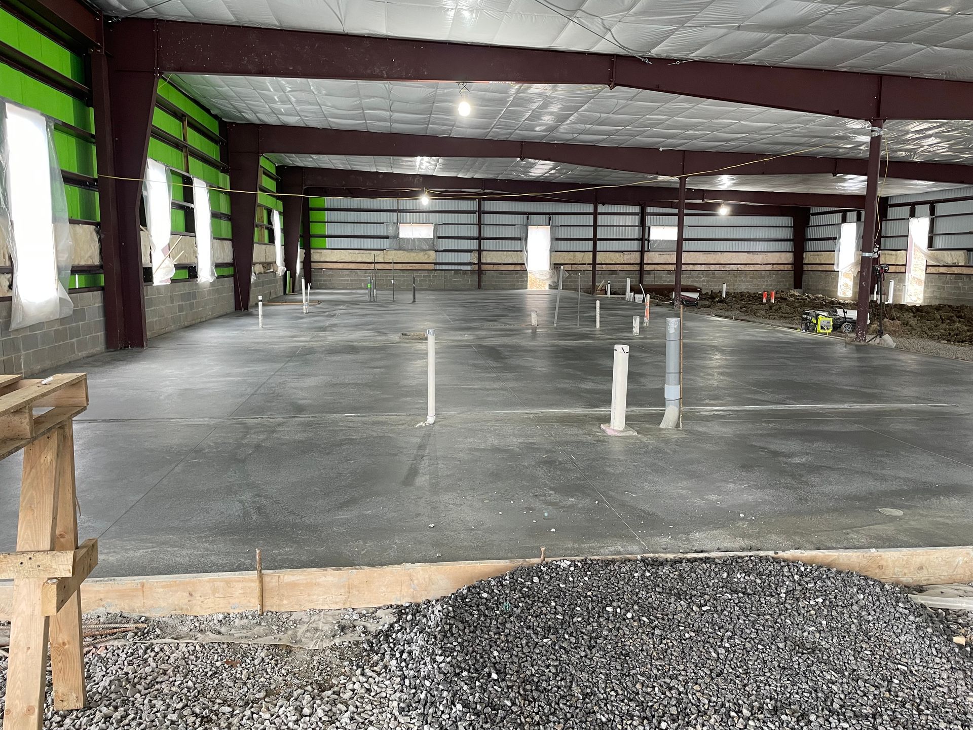 The inside of a building under construction with a concrete floor.