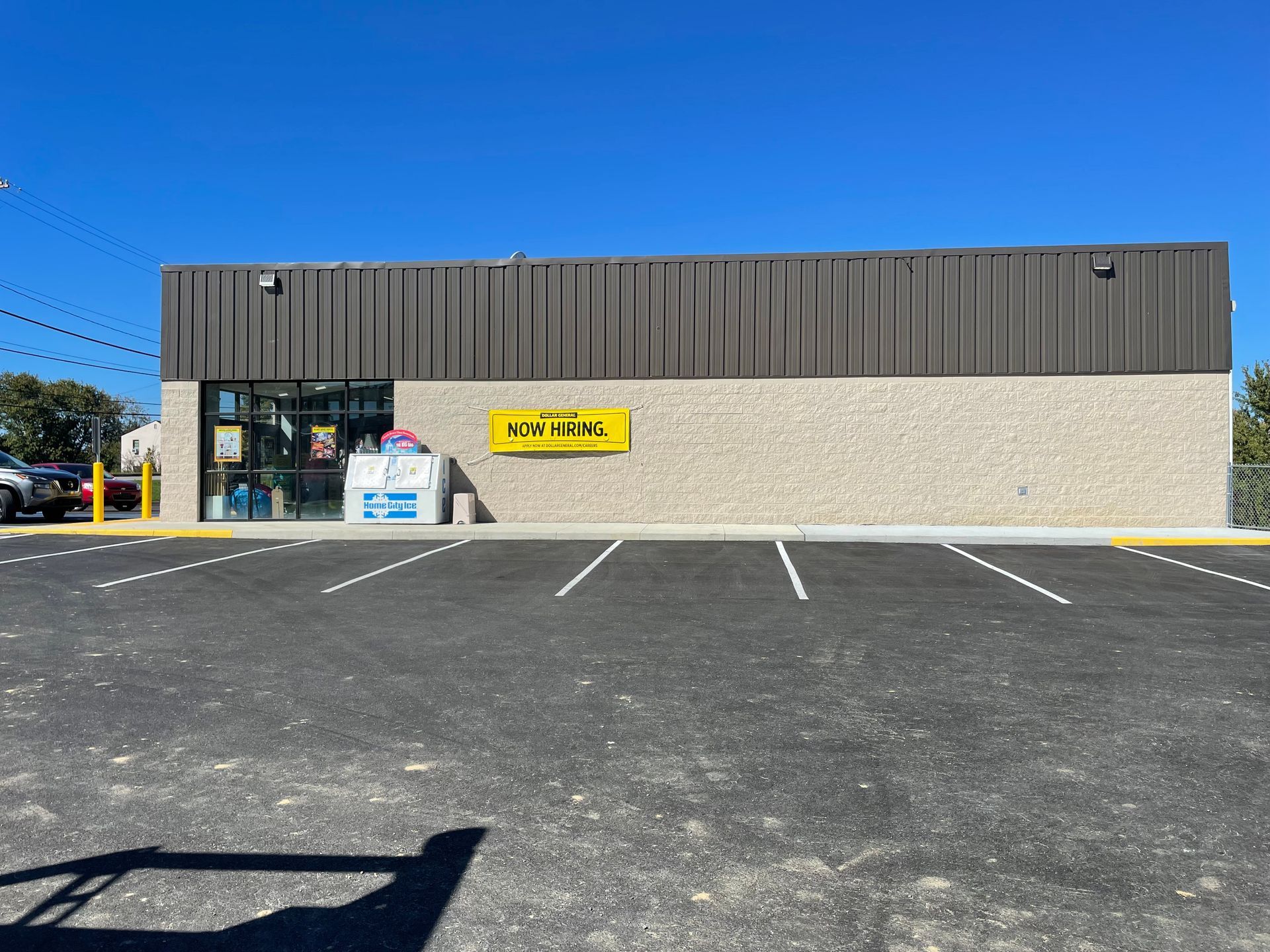 A large brick building with a parking lot in front of it.
