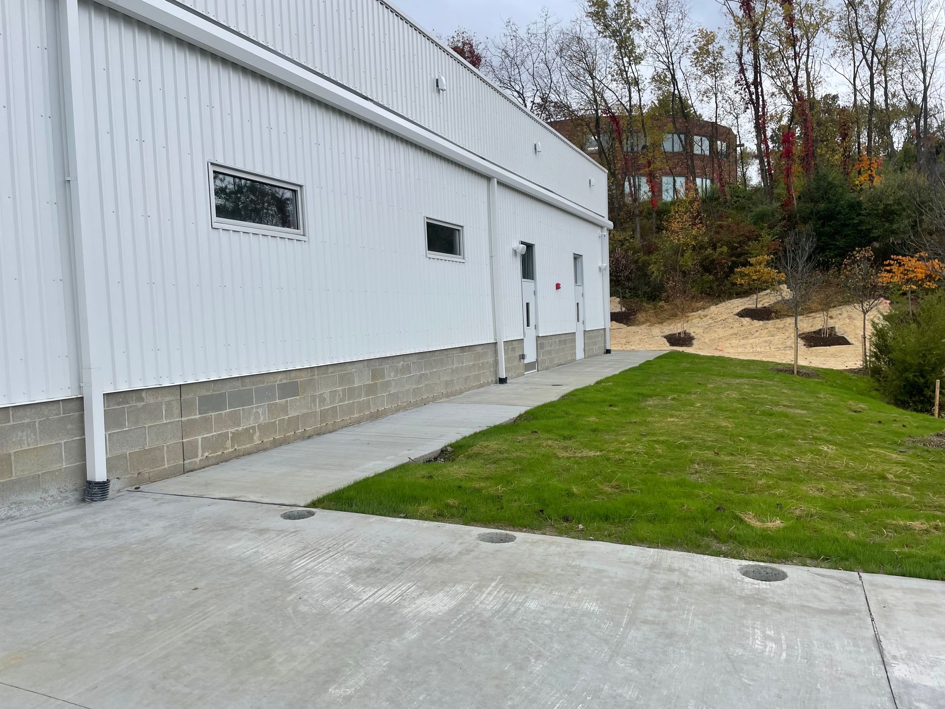 A large white building with a concrete walkway leading to it.