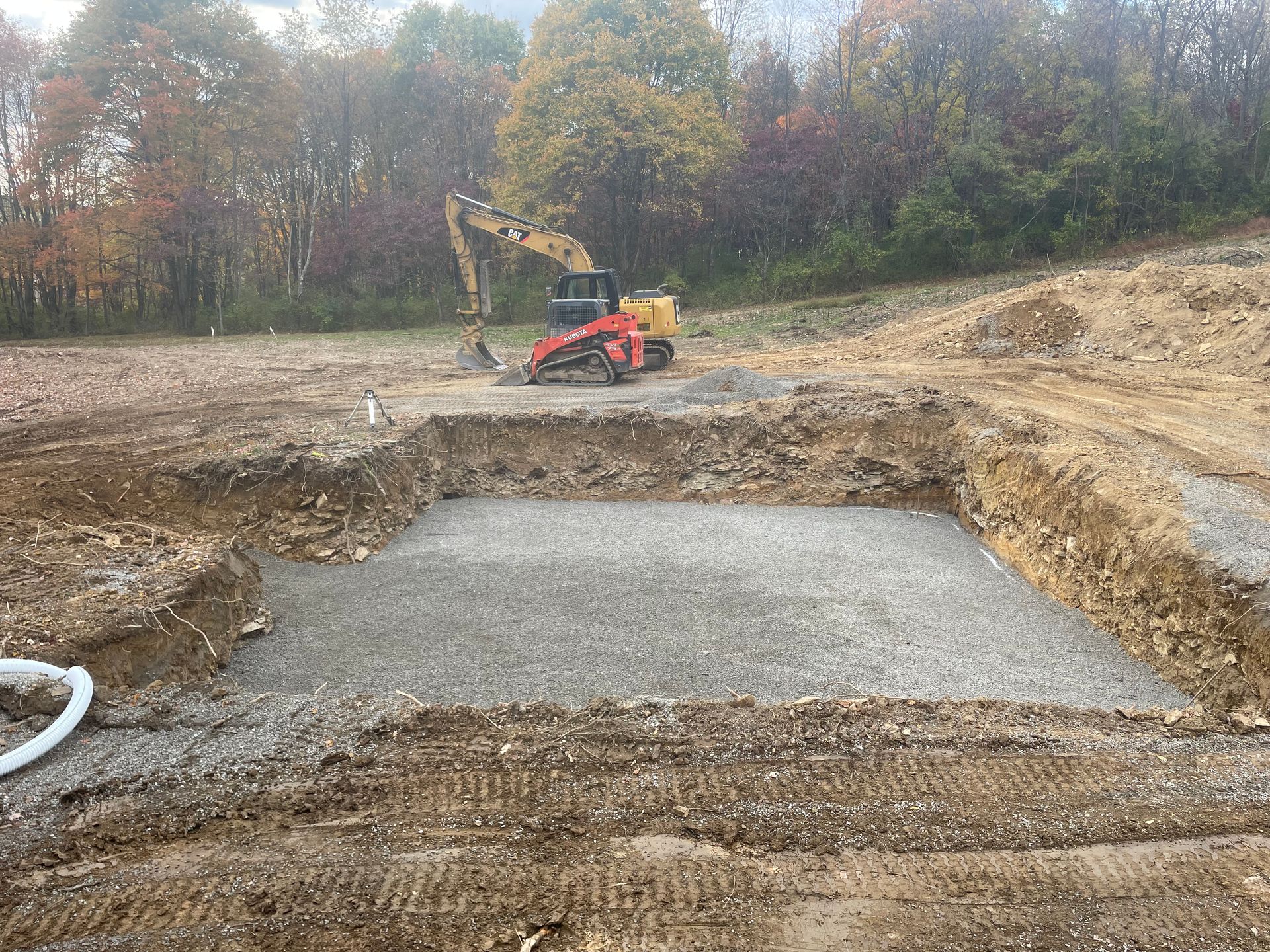 A bulldozer is digging a hole in the dirt in a field.