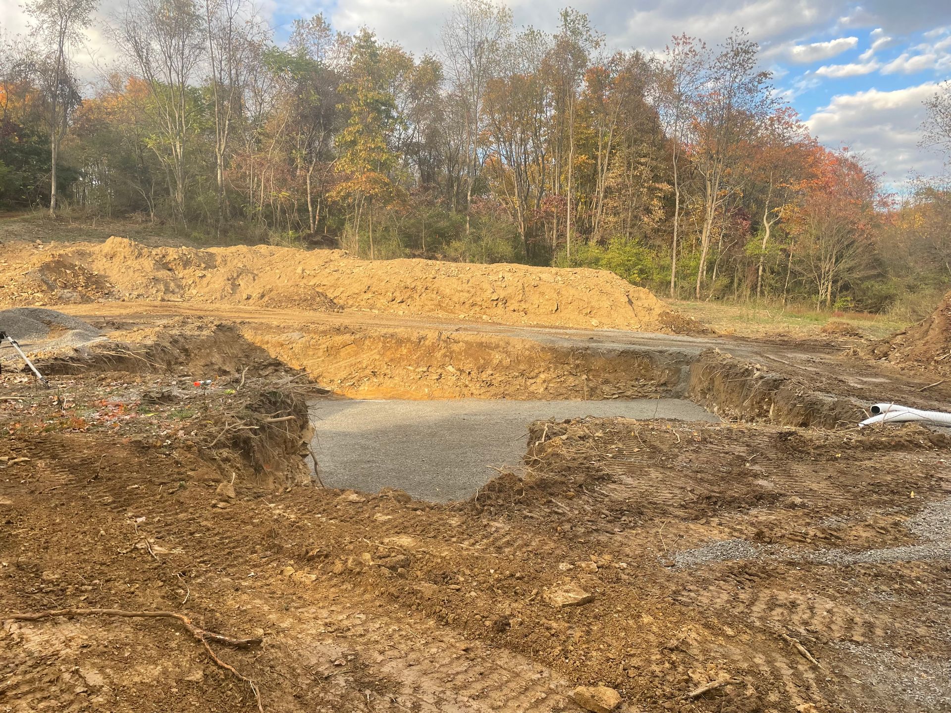 A large pile of dirt is sitting in the middle of a field.