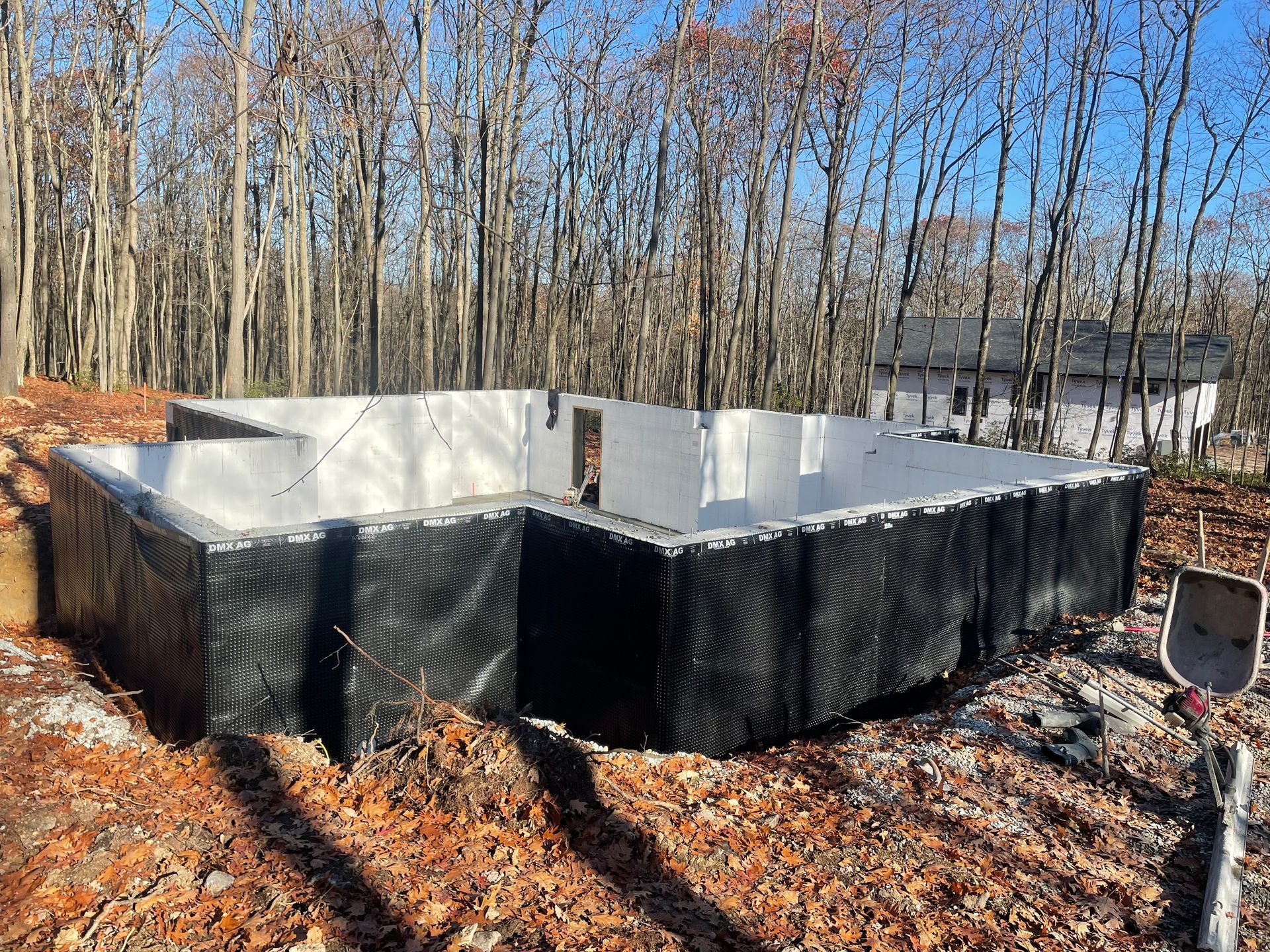 A foundation for a house is being built in the woods.