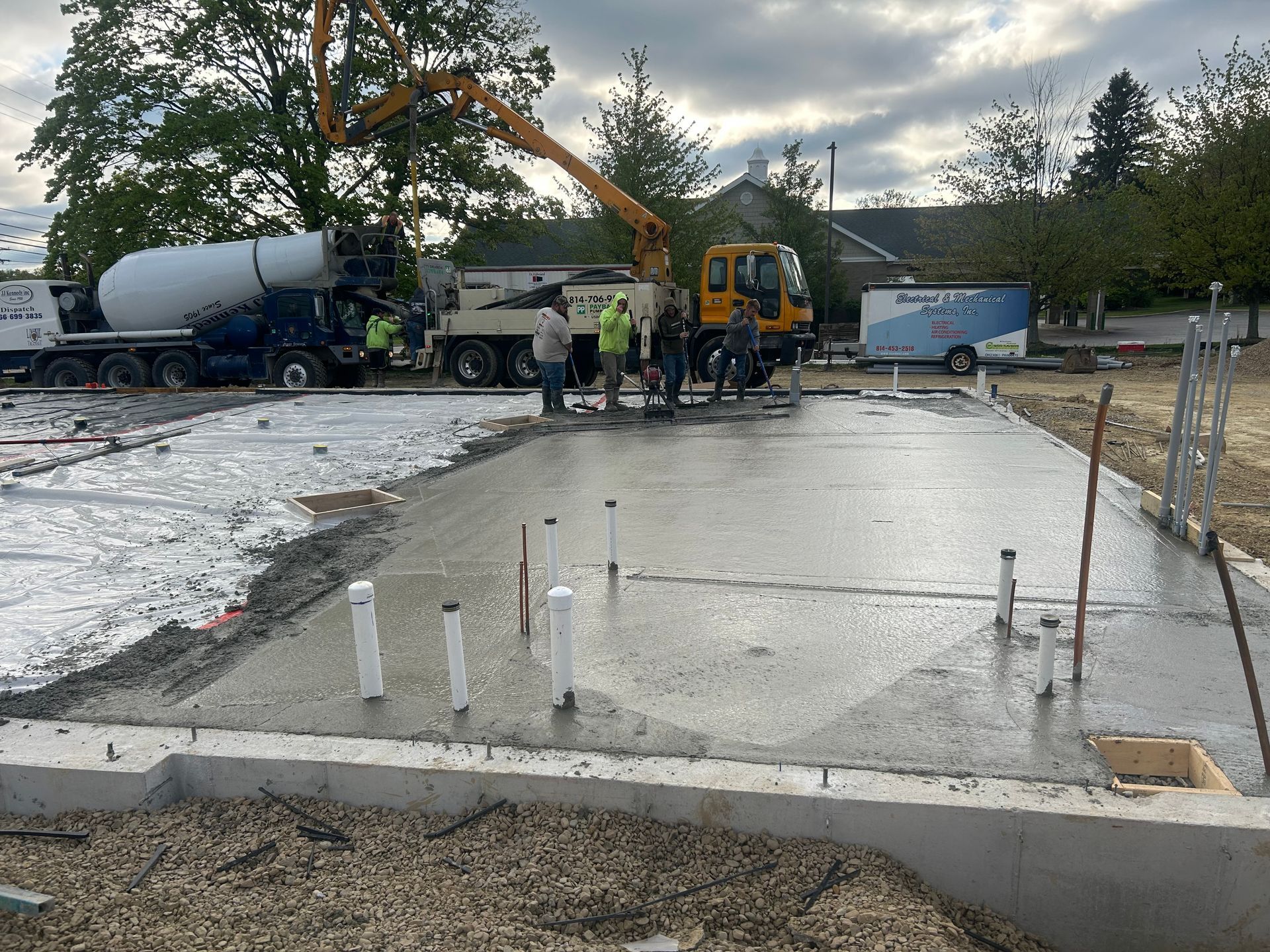 A concrete pump is being used to pour concrete into a foundation