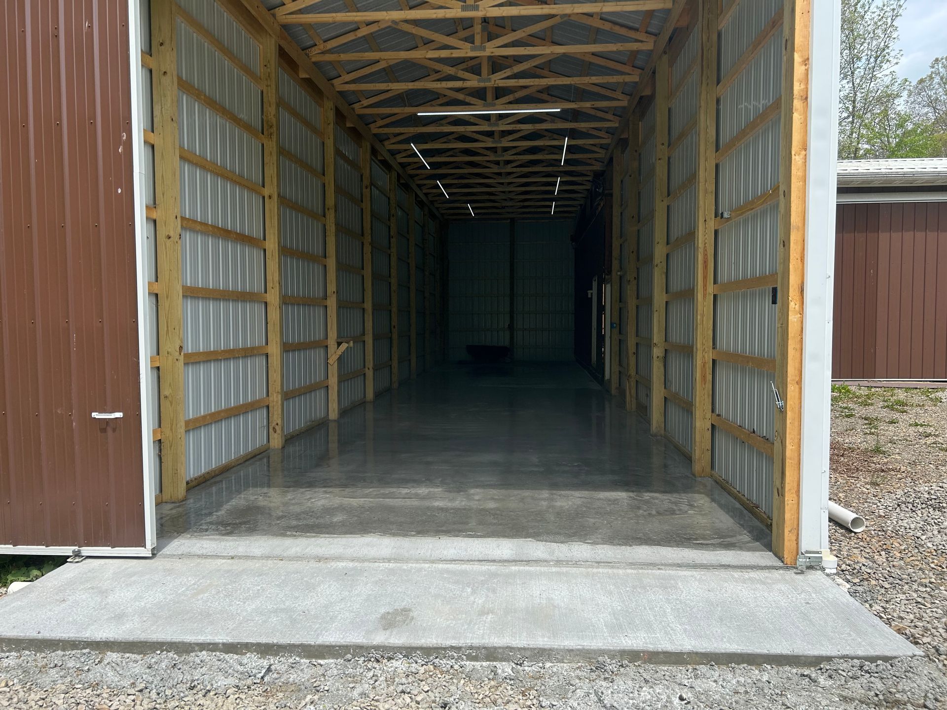 A large warehouse with a concrete floor and wooden walls.
