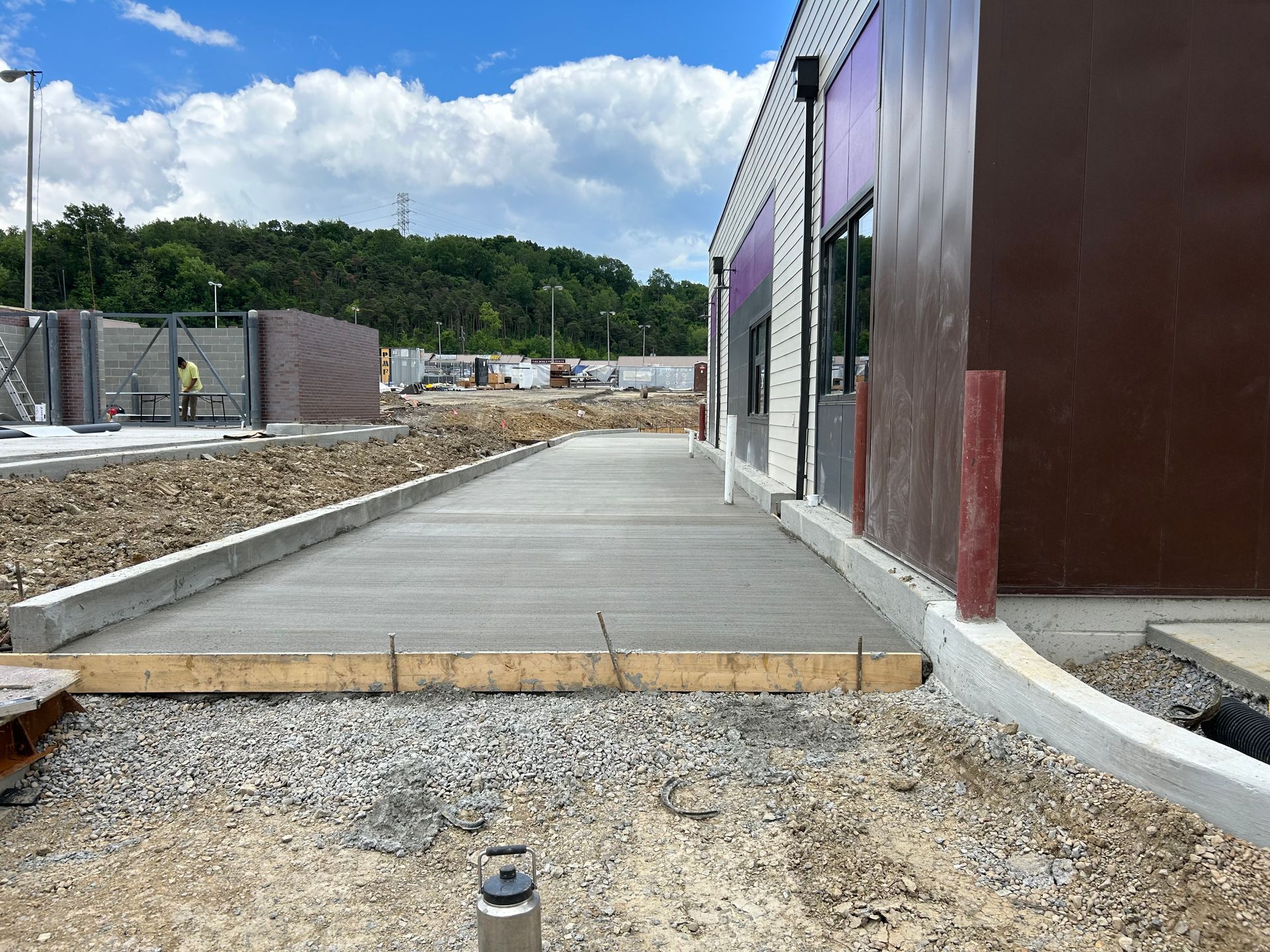 A concrete walkway is being built in front of a building.