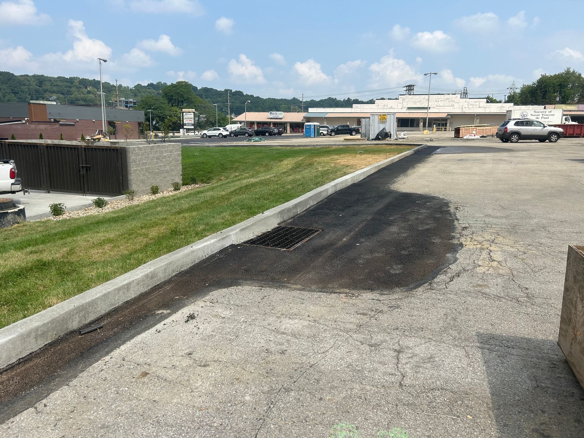 A parking lot with a lot of cars parked in it and a building in the background.